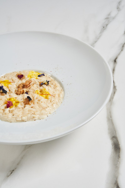 Risotto with Grancrema cheese sauce with PDO Taleggio cheese, walnut sauce and saffron drops