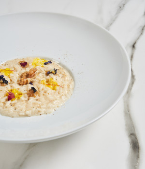 Risotto with Grancrema cheese sauce with PDO Taleggio cheese, walnut sauce and saffron drops