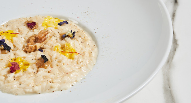 Risotto with Grancrema cheese sauce with PDO Taleggio cheese, walnut sauce and saffron drops