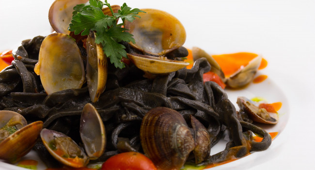 Squid ink fettuccine with clams and datterini tomatoes sauce