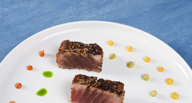 TUNA MARINATED IN SWEET AND SOUR SOY SAUCE, SAUTÉED WITH BLUE POPPY AND SESAME SEEDS AND SERVED WITH GUACAMOLE SAUCE